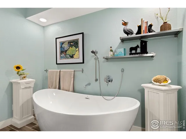 a white bath tub sitting next to a white toilet and sink