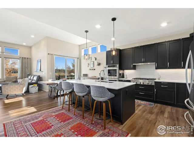 a kitchen with kitchen island granite countertop a sink counter top space and appliances