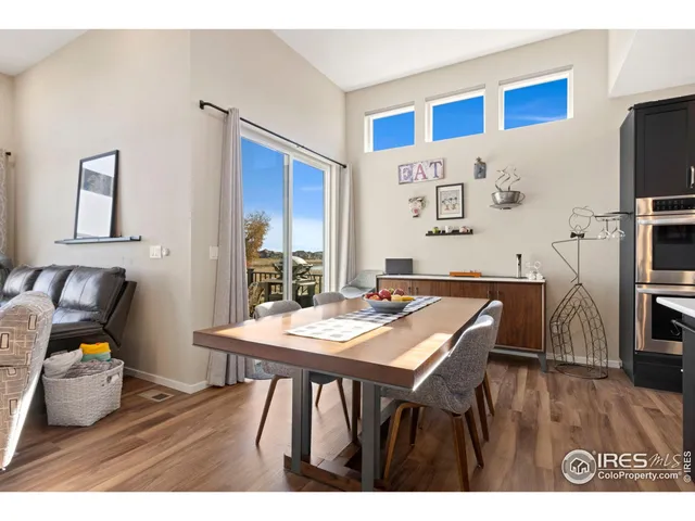 a view of a dining room with furniture and a flat screen tv