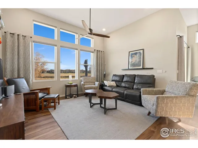 a living room with fireplace furniture and a large window