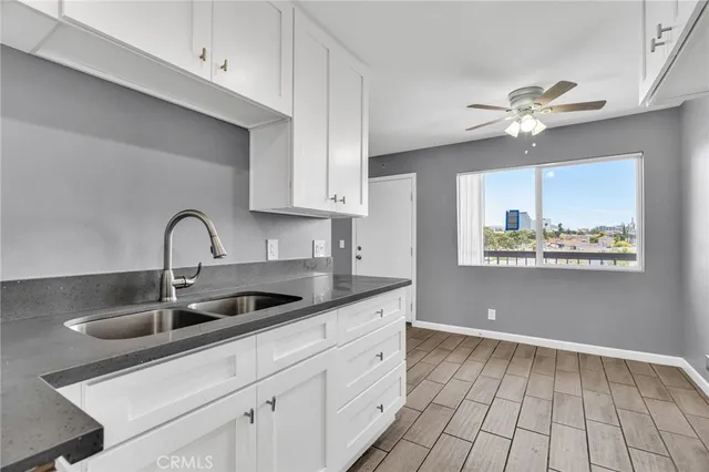 a kitchen with a sink cabinets and appliances