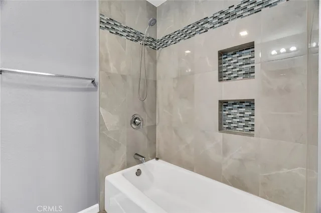 a bathroom with a bathtub a shower and a shower