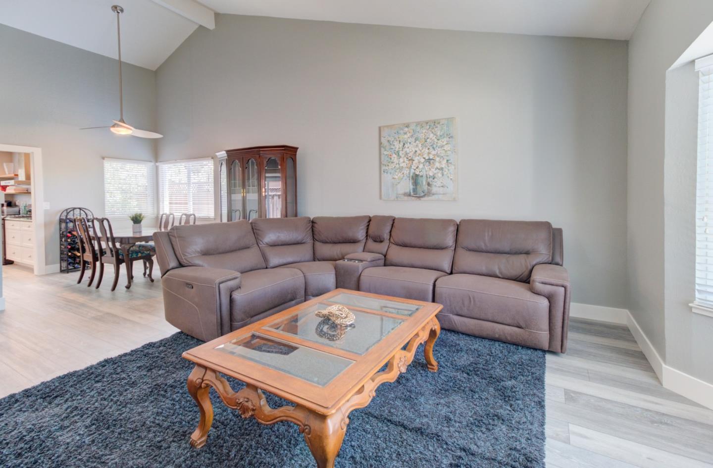 15120 Venetian Way Morgan Hill, CA 95037 - Photo 19 of 39 a living room with furniture a table and a painting on the wall