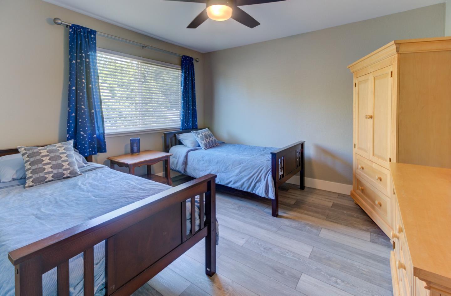 15120 Venetian Way Morgan Hill, CA 95037 - Photo 27 of 39 a bedroom with two beds and a chandelier