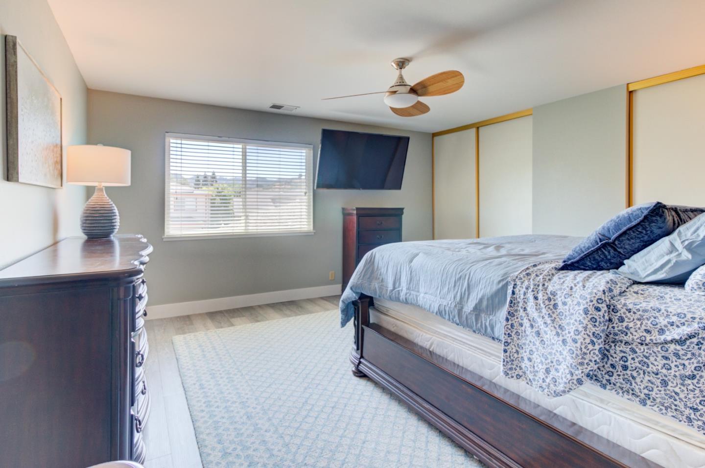 15120 Venetian Way Morgan Hill, CA 95037 - Photo 33 of 39 a bedroom with a bed and a chandelier