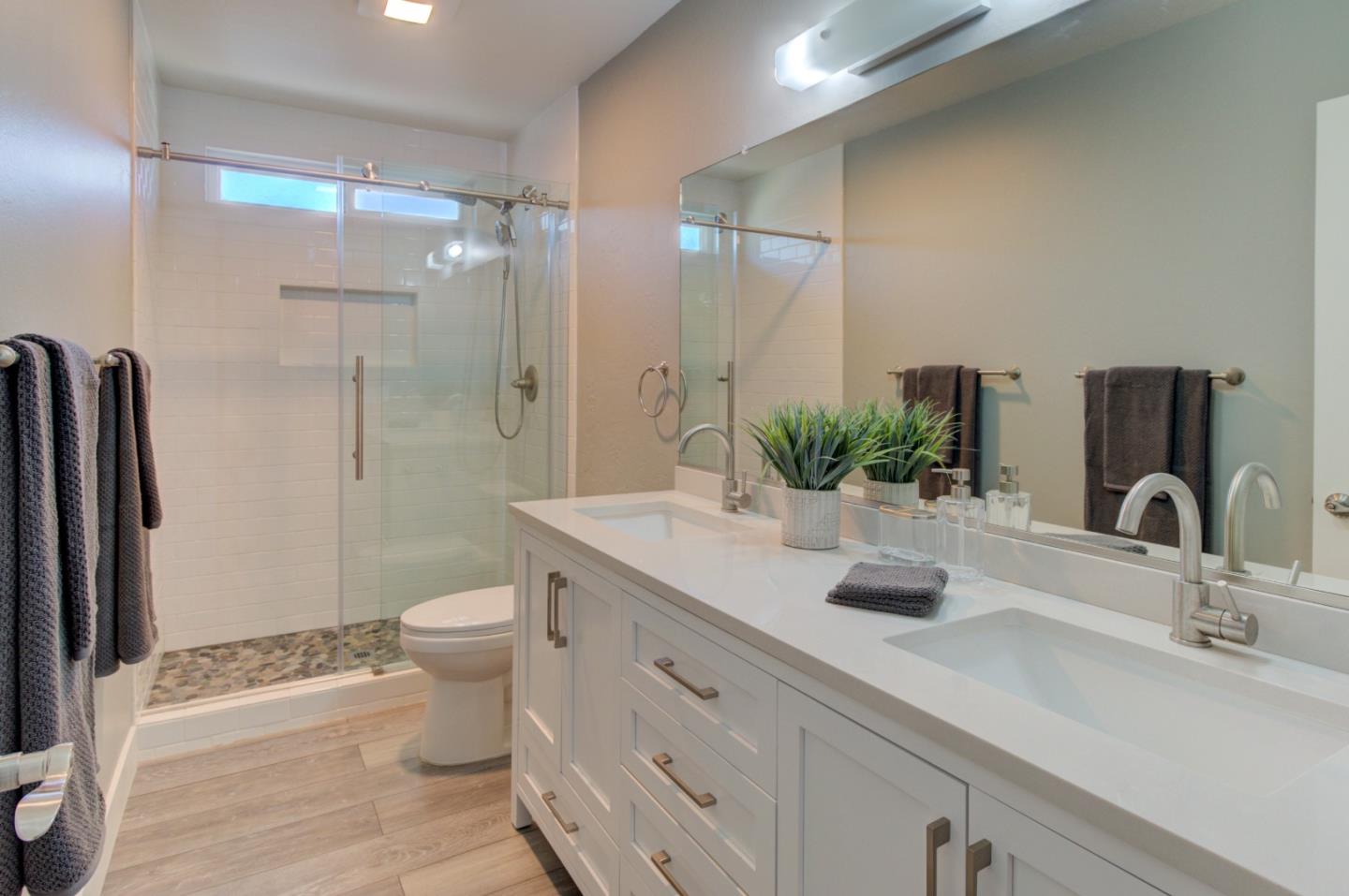 15120 Venetian Way Morgan Hill, CA 95037 - Photo 34 of 39 a bathroom with a double vanity sink toilet and shower