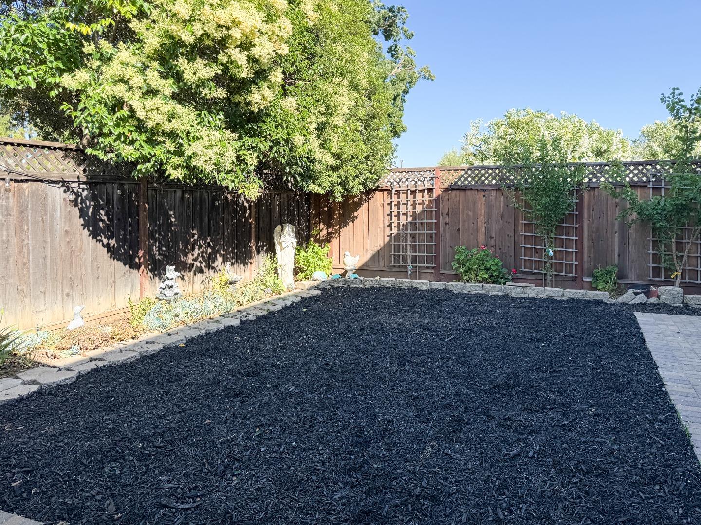 15120 Venetian Way Morgan Hill, CA 95037 - Photo 38 of 39 a view of a yard with plants and a wooden fence