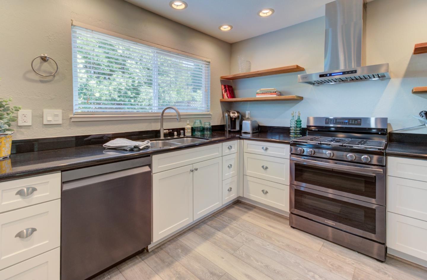 15120 Venetian Way Morgan Hill, CA 95037 - Photo 8 of 39 a kitchen with granite countertop a stove sink and cabinets