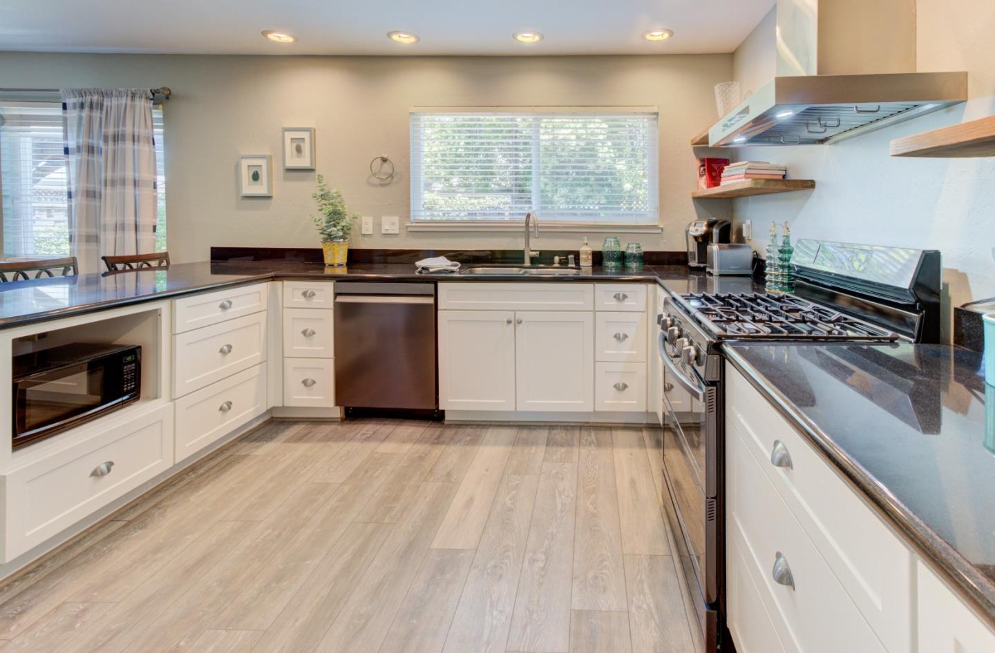 15120 Venetian Way Morgan Hill, CA 95037 - Photo 9 of 39 a kitchen with a stove a sink and wooden floor