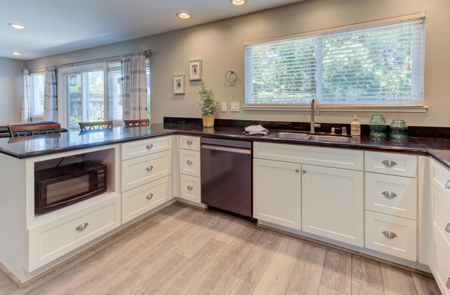 15120 Venetian Way Morgan Hill, CA 95037 - Photo 10 of 39 a kitchen with granite countertop white cabinets and white appliances