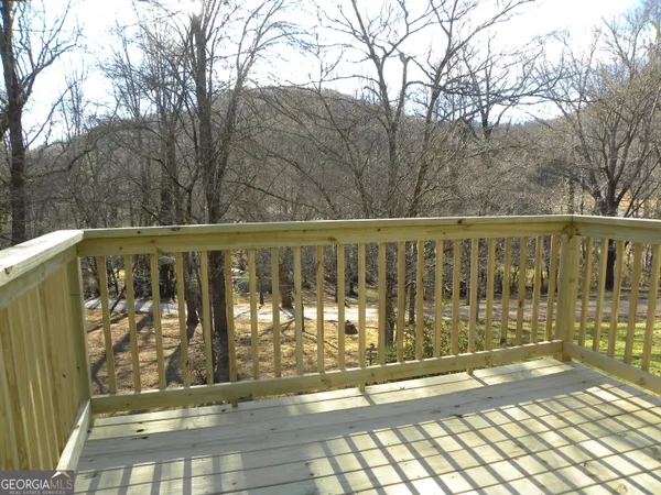 a view of a balcony with wooden fence