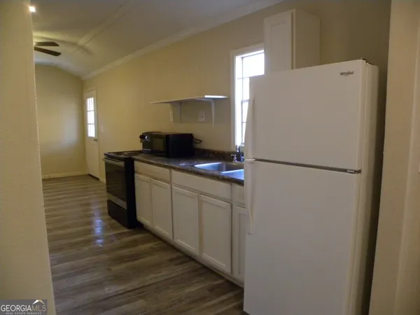 a kitchen with a refrigerator and a sink