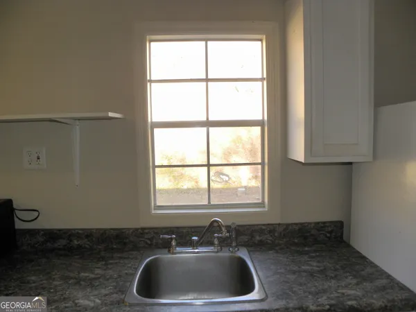 a bathroom with a sink and a window