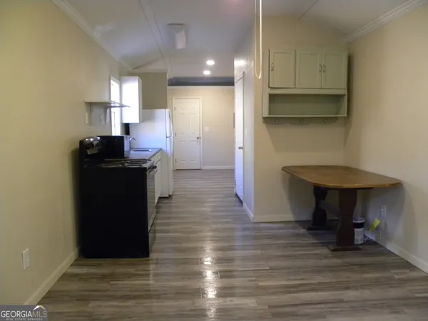 a kitchen with kitchen island wooden cabinets and a sink