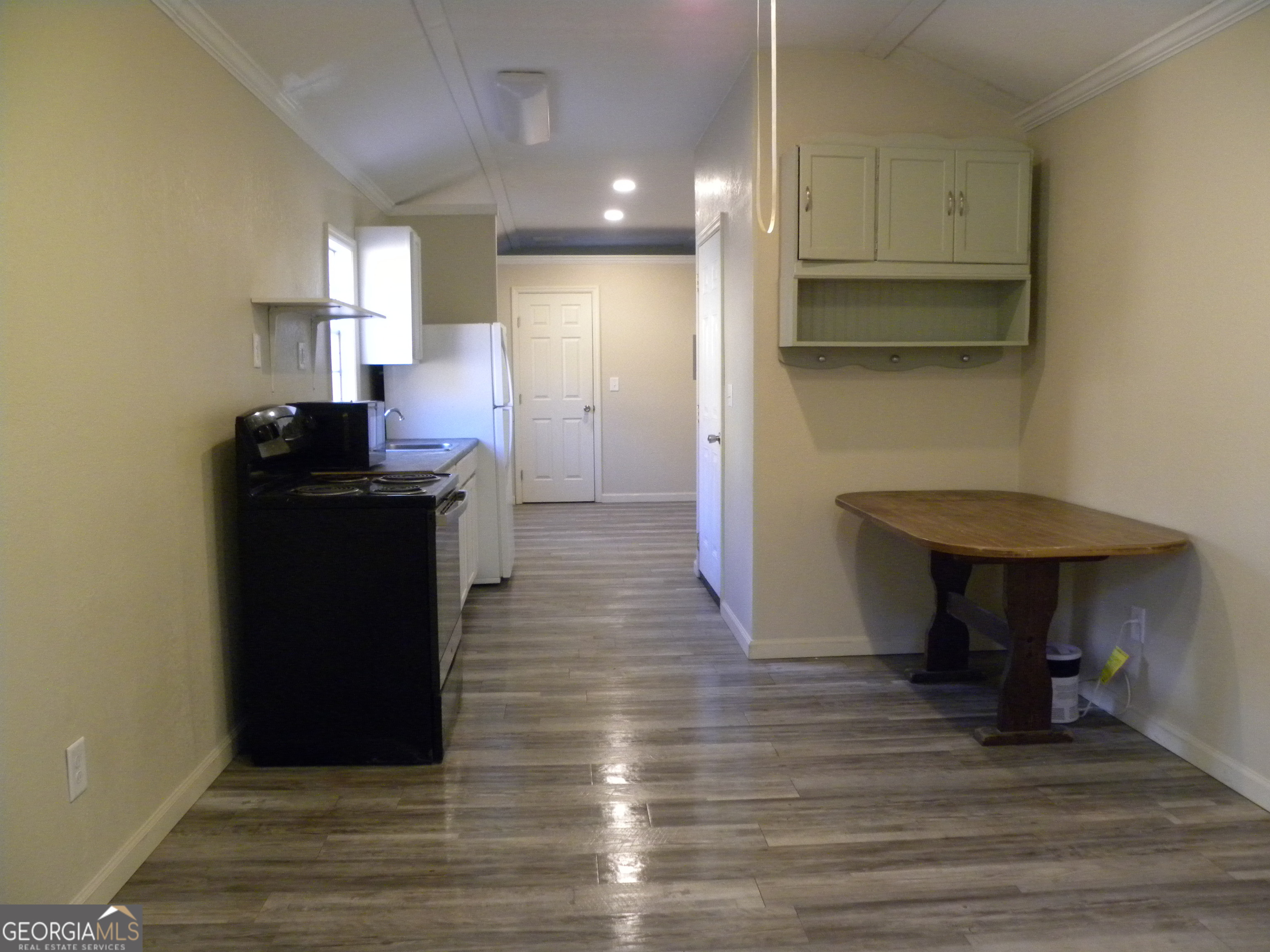 105 West Z Clayton, GA 30562 - Photo 8 of 20 a kitchen with kitchen island wooden cabinets and a sink