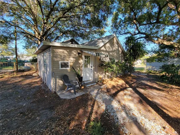 a view of a house with yard and sitting area