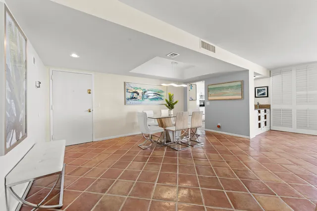 a living room with a gaming machine and chairs