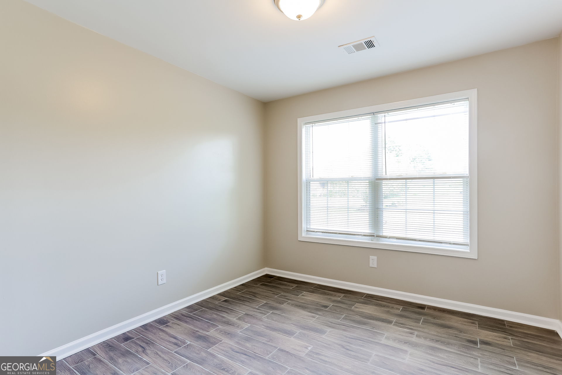 147 Portland Road Aragon, GA 30104 - Photo 12 of 17 an empty room with wooden floor and windows