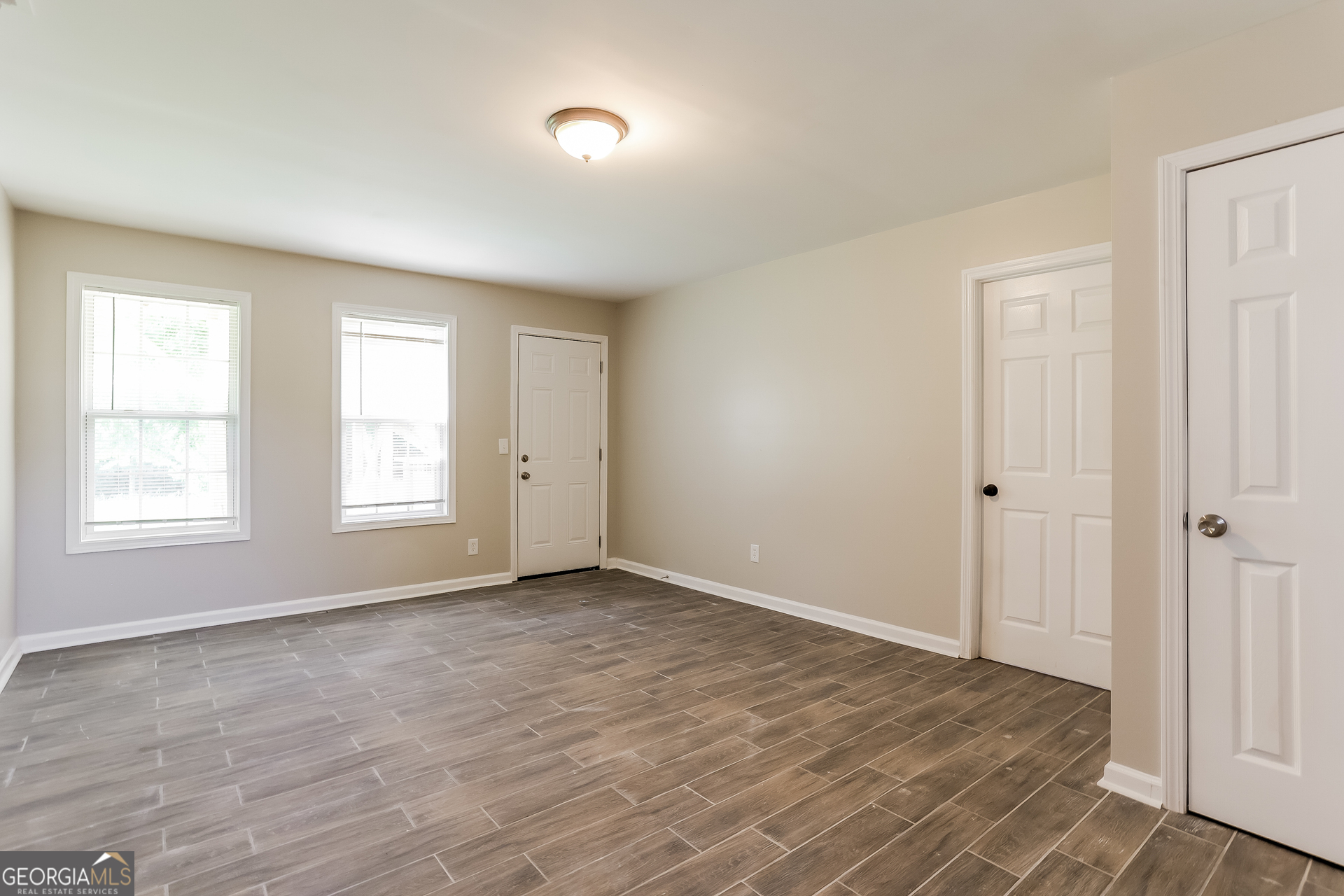 147 Portland Road Aragon, GA 30104 - Photo 13 of 17 a view of an empty room with wooden floor and a window