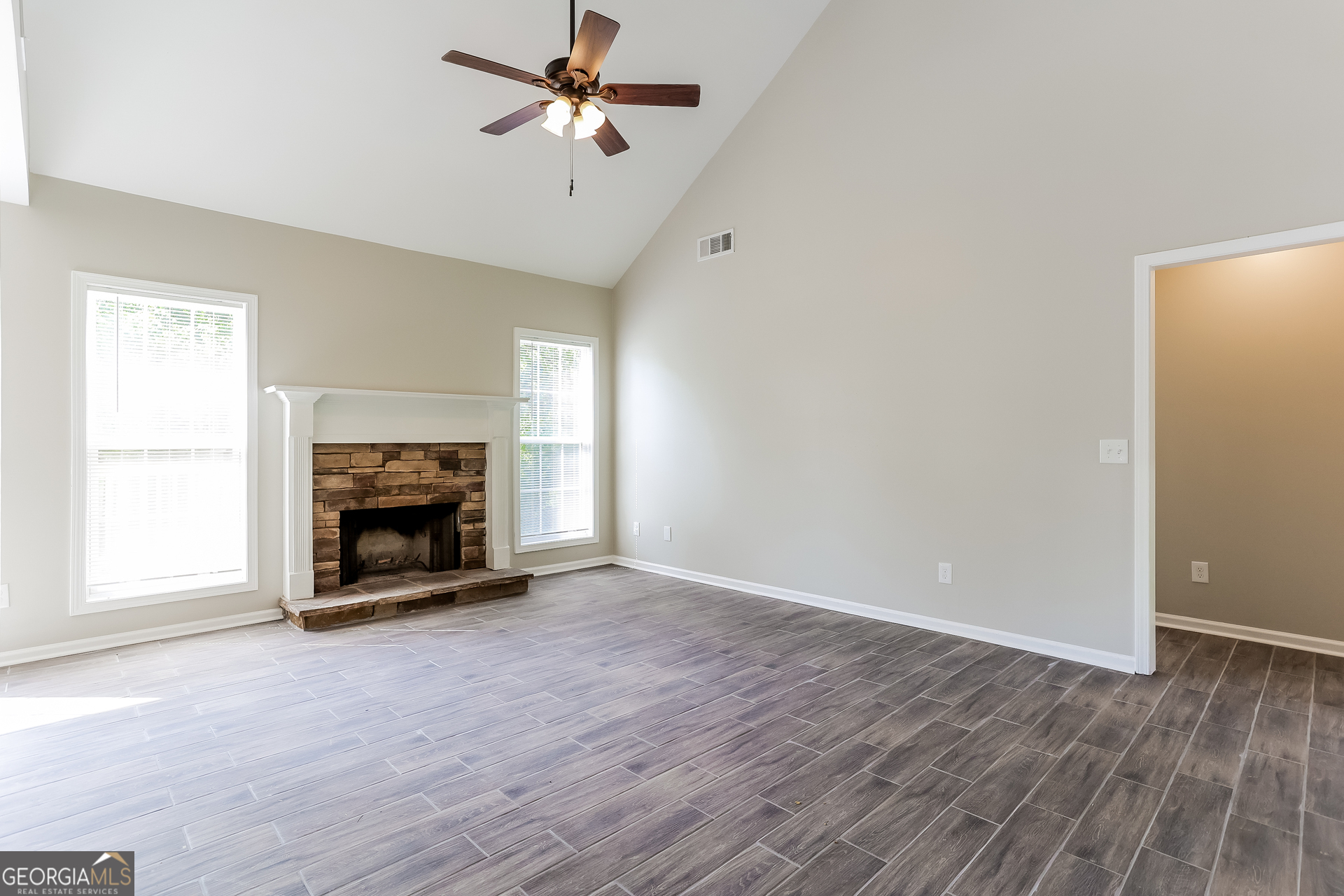 147 Portland Road Aragon, GA 30104 - Photo 3 of 17 an empty room with windows and a fireplace