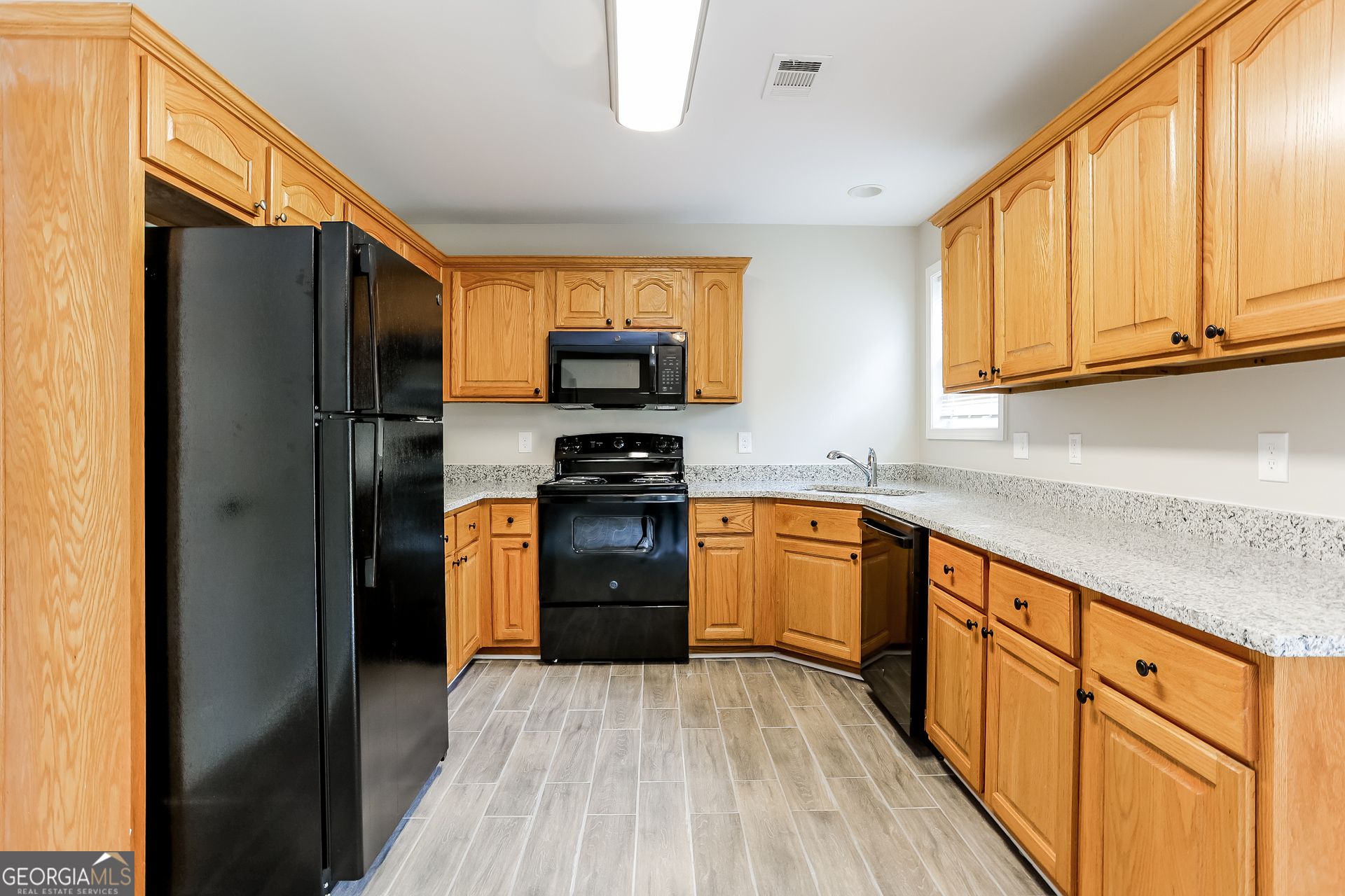 147 Portland Road Aragon, GA 30104 - Photo 6 of 17 a kitchen with stainless steel appliances granite countertop a refrigerator stove and sink