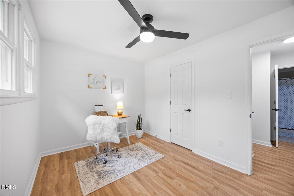 3437 Apache Drive Raleigh, NC 27609 - Photo 26 of 40 Wood-finish flooring, white walls, and a black ceiling fan with integrated lighting