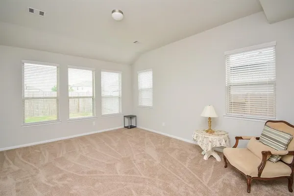 a view of a bedroom with furniture and windows