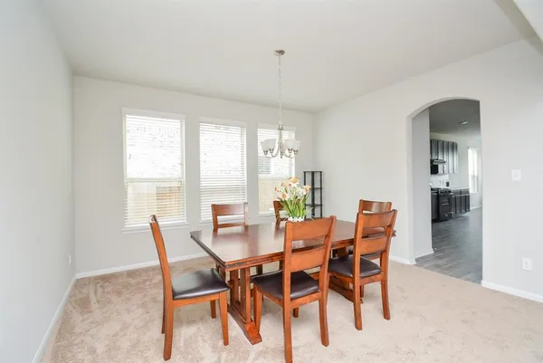 a view of a dining room with furniture and a window