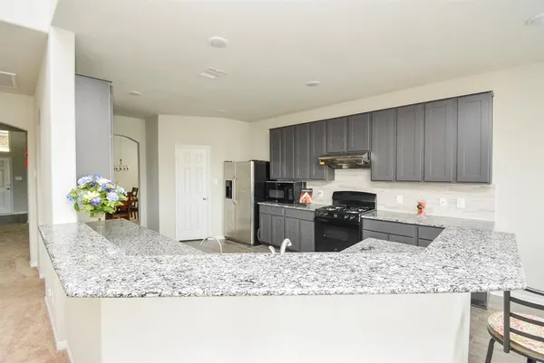 a kitchen with a granite counter tops and a wooden cabinets