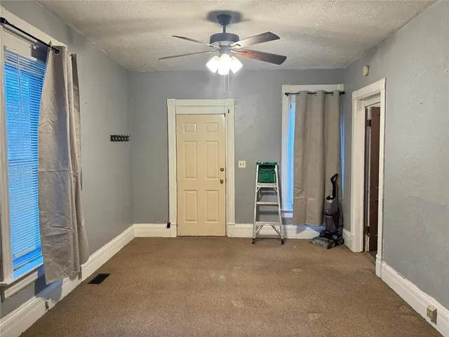 a view of empty room with ceiling fan