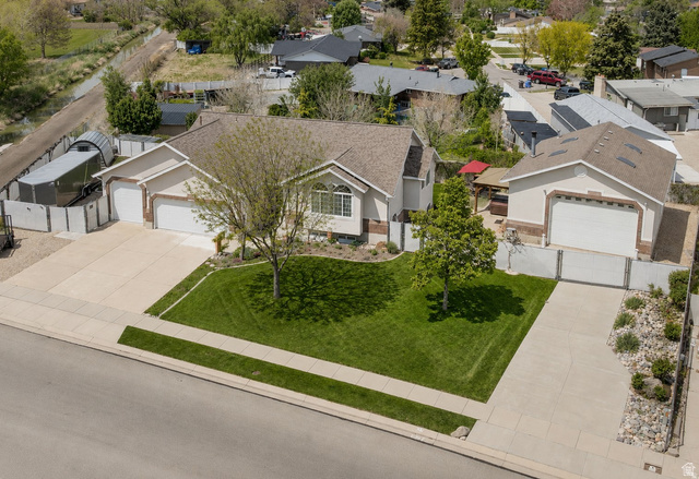 3778 Mapleleaf Way West Jordan, UT 84088 - Photo 4 of 55 Contemporary stucco residence with a two-car attached garage and an additional detached garage