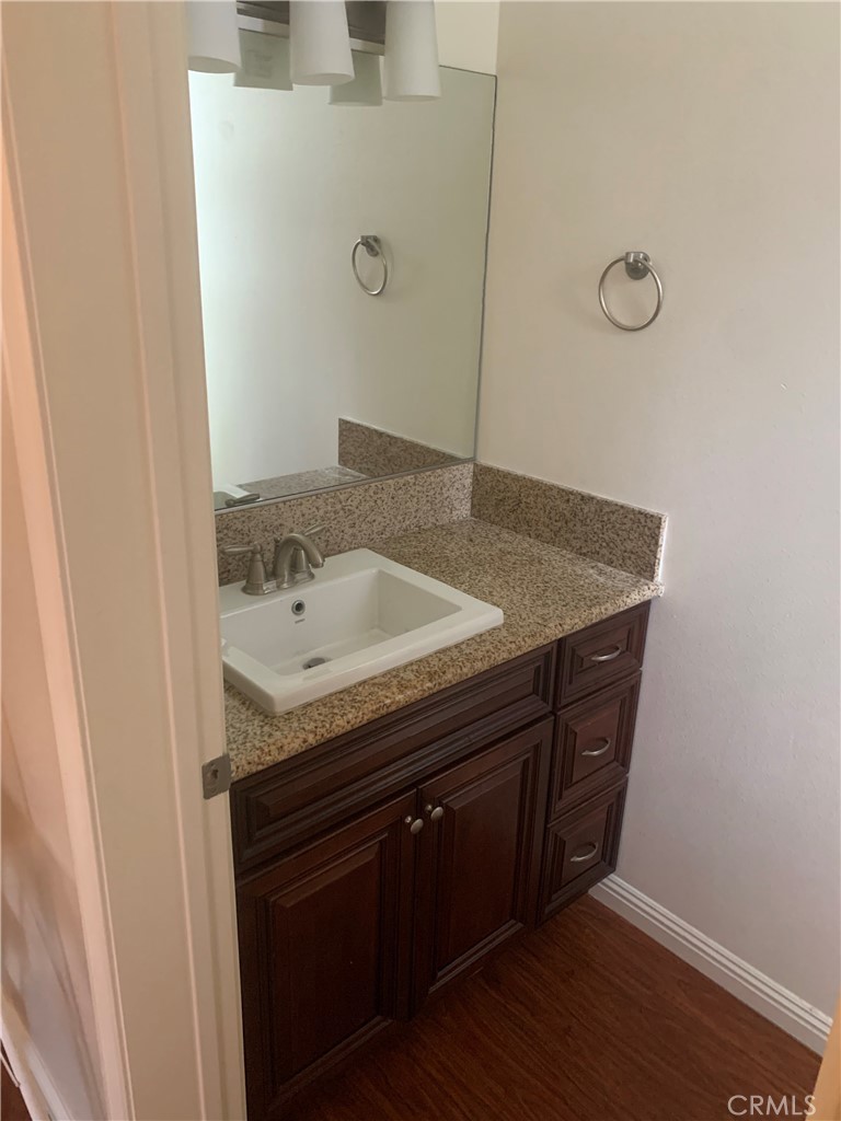920 Central Avenue, Unit 101 Riverside, CA 92507 - Photo 12 of 23 a bathroom with a granite countertop sink and a mirror