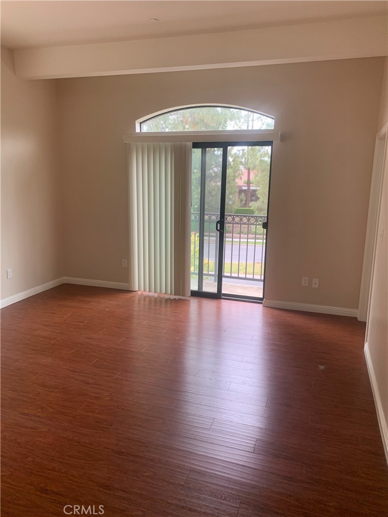 920 Central Avenue, Unit 101 Riverside, CA 92507 - Photo 15 of 23 a view of an empty room with wooden floor and a window
