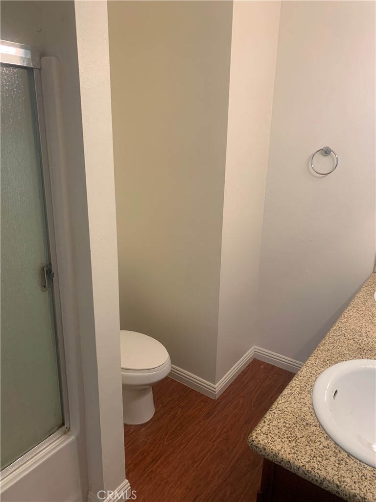 920 Central Avenue, Unit 101 Riverside, CA 92507 - Photo 18 of 23 a bathroom with a granite countertop sink and a toilet
