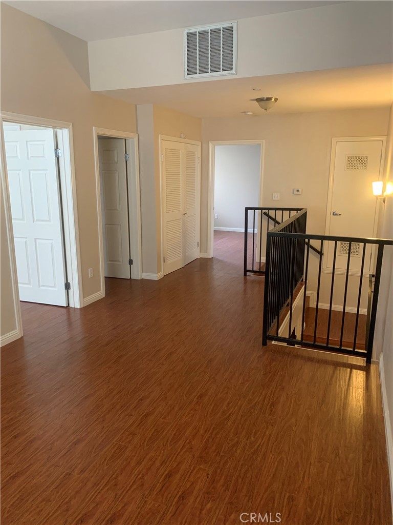 920 Central Avenue, Unit 101 Riverside, CA 92507 - Photo 19 of 23 a view of a room with wooden floor and stairs