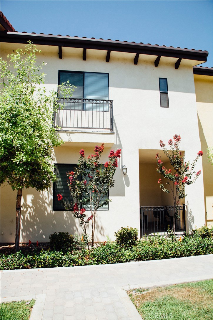 920 Central Avenue, Unit 101 Riverside, CA 92507 - Photo 2 of 23 a front view of a house with a yard and garage