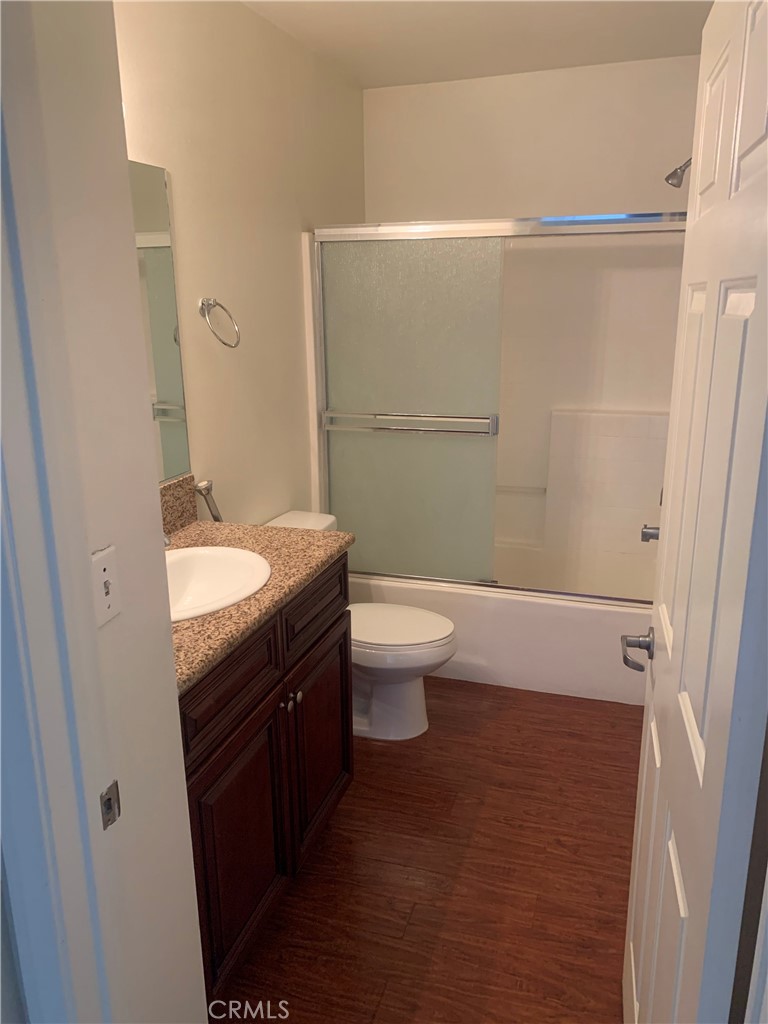 920 Central Avenue, Unit 101 Riverside, CA 92507 - Photo 22 of 23 a bathroom with a granite countertop sink toilet and shower