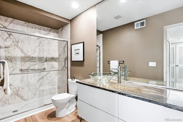 a bathroom with a granite countertop sink and a mirror