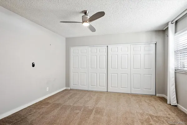 an empty room with windows and closet
