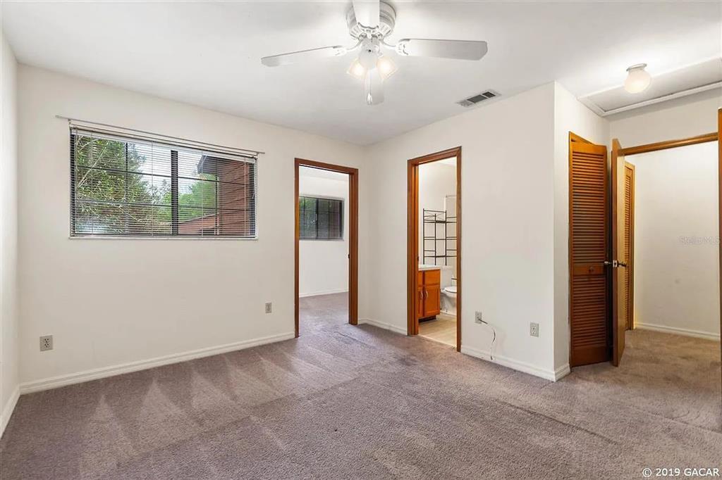 960 Southwest 55th Terrace Gainesville, FL 32607 - Photo 3 of 8 an empty room with windows and closet