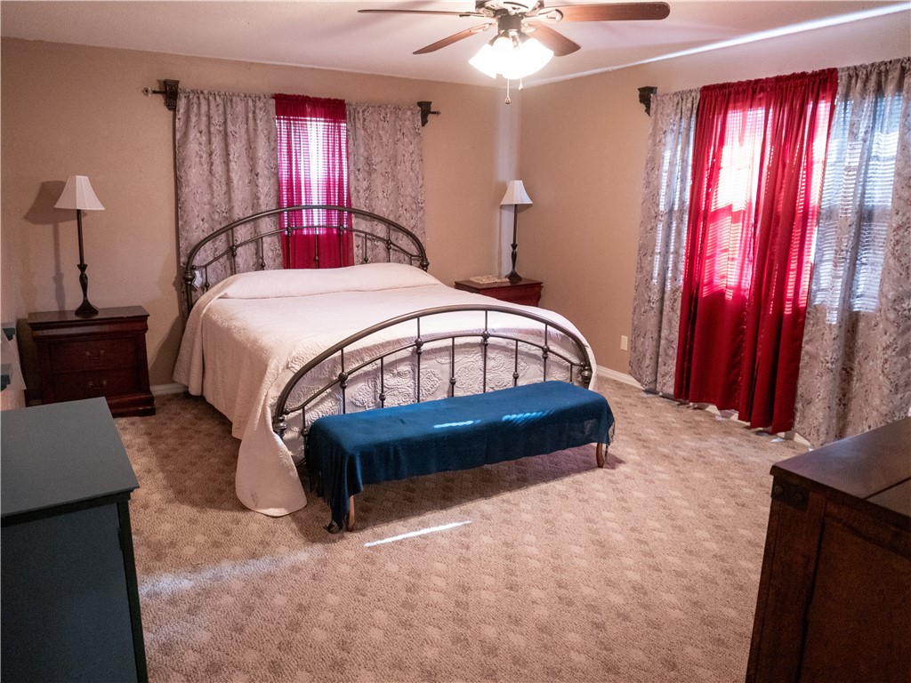 372 East Fm 771 Riviera, TX 78379 - Photo 25 of 40 a bed sitting in a bedroom next to a window and a chandelier