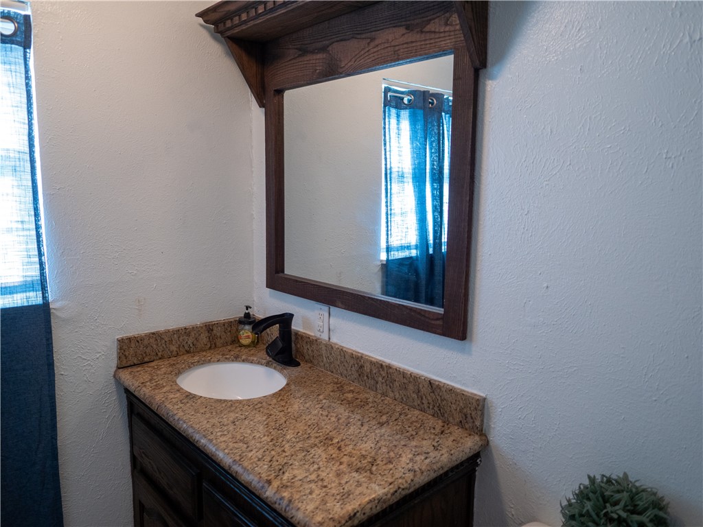 372 East Fm 771 Riviera, TX 78379 - Photo 29 of 40 a bathroom with a granite countertop sink and a mirror