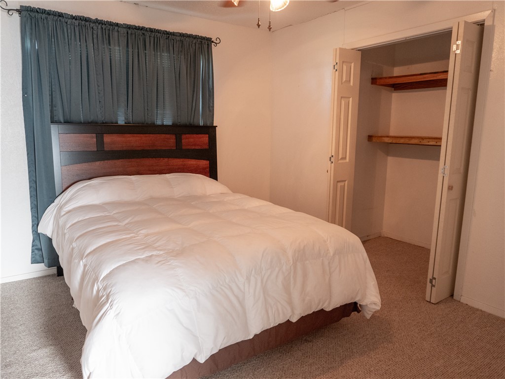 372 East Fm 771 Riviera, TX 78379 - Photo 32 of 40 a bed sitting in a bedroom next to a wooden cabinet