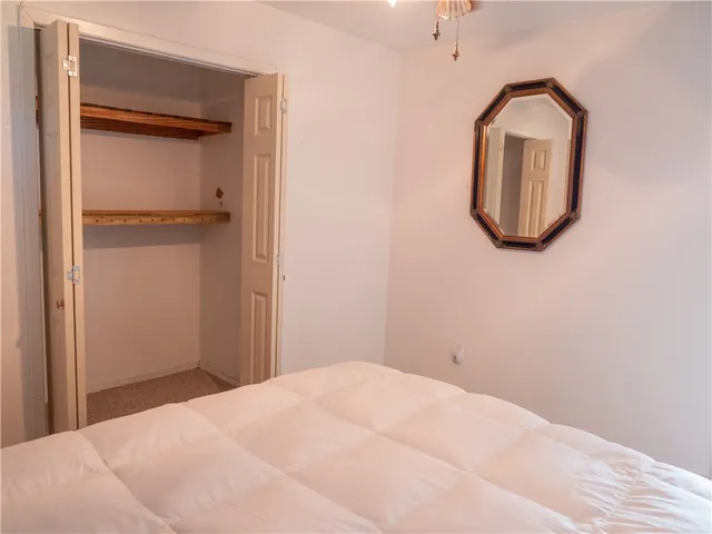 a bedroom with a bed and a mirror