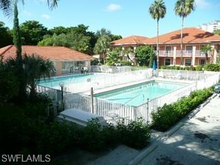 519 Roma Court, Unit 207 Naples, FL 34110 - Photo 8 of 8 a view of a house with garden and a swimming pool