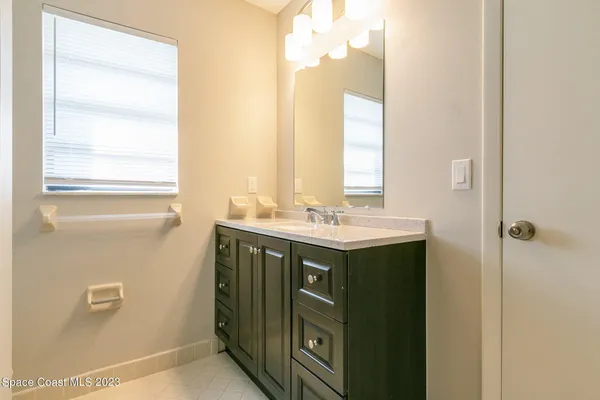 a bathroom with a sink vanity and a mirror