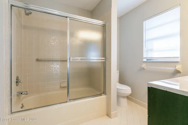 a bathroom with a shower and a toilet