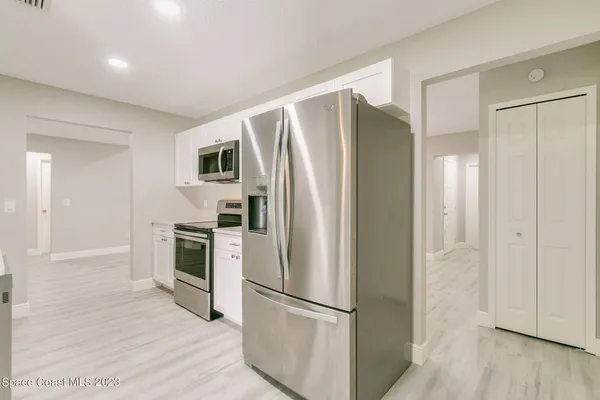 a kitchen with stainless steel appliances a refrigerator sink and cabinets