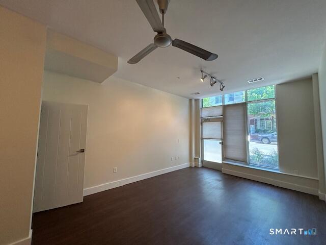 111 Morgan Street, Unit TH5 Stamford, CT 06905 - Photo 7 of 23 an empty room with wooden floor cabinet and windows