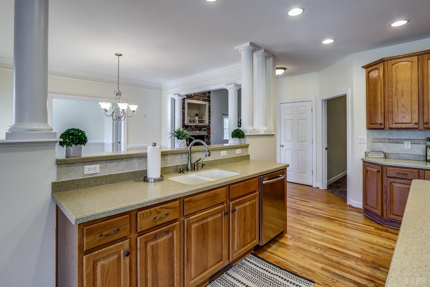 1315 Donnally Road Forest, VA 24551 - Photo 19 of 74 a kitchen with stainless steel appliances granite countertop a sink a stove and a wooden floors